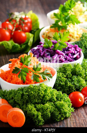 Zusammensetzung mit vier Salat Schüsseln auf hölzernen Tisch Stockfoto