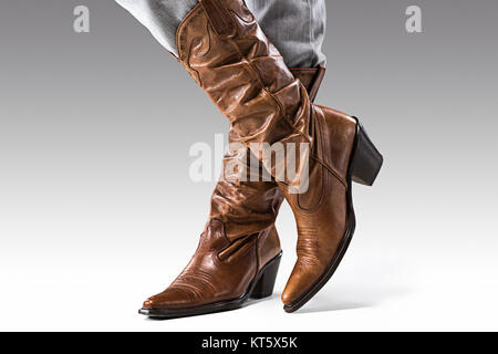 Beine in Jeans und Stiefeln Cowboys Stockfoto
