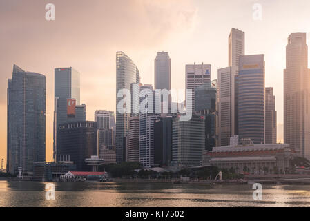 Singapur Wolkenkratzer mit Merlion Park Blick von Singapur Bucht im Abendlicht. Stockfoto