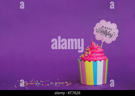 Lecker Erdbeer Kuchen mit Streuseln und Happy Birthday Banner auf violett unterlegt. Party Hintergrund Stockfoto