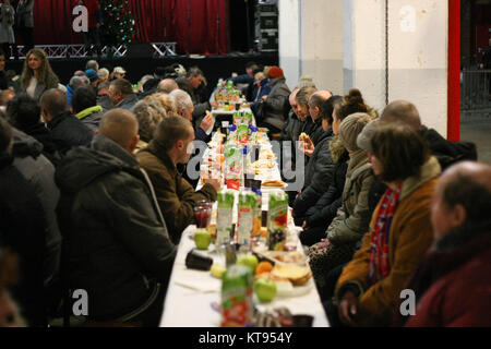 Danzig, Polen. 23 Dez, 2017. Über 500 Menschen nehmen an den Weihnachtsabend Mahlzeit in Danzig, Polen, am 23. Dezember traditionelle polnische Weihnachten Mahlzeit 2017 wurde von christlichen Organisationen organisiert. Personen ein spezielles Wafer beim Austausch von Weihnachtsgrüße. Obdachlosen und Armen wurden mit traditionellen polnischen Bigos, Pierogi, Brot und Kuchen bewirtet. Quelle: Michal Fludra/Alamy leben Nachrichten Stockfoto