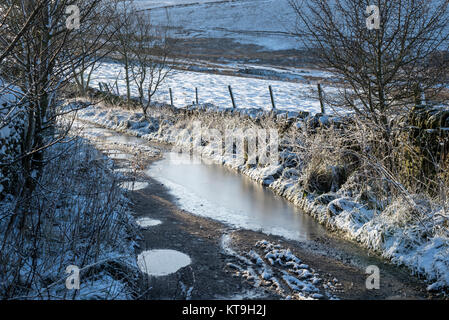 Eisige Country Track in den Hügeln des Peak District an einem frostigen Dezember Morgen. Rowarth, Derbyshire, England. Stockfoto