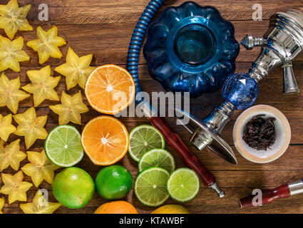 Shisha auf Holz- Hintergrund, mit Zitrusfrüchten, Orangen, Zitronen und Sternfrucht Stockfoto