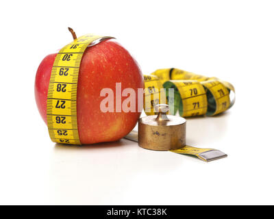 Diät oder Gewichtsverlust Gewinn Konzept Bild mit einem Maßband und Apfel, isoliert auf weiss Stockfoto