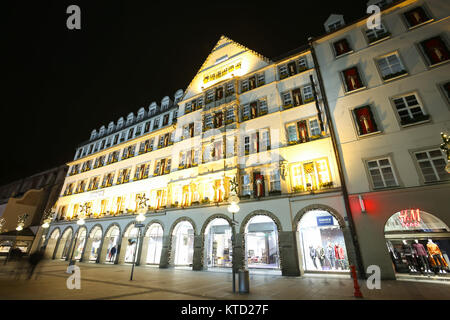 München, Deutschland - Dezember 11, 2017: Ein Blick auf die eingerichtete beleuchtete Fassade des Hirmer Kaufhaus in der Nacht in München, Deutschland. Stockfoto