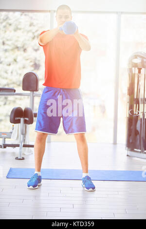 Crossfit Training. Fitness Mensch tut ein Krafttraining durch Anheben kettlebell. Junge Sportler tun kettlebell Schaukeln. Bodybuilder anheben kettlebell. C Stockfoto