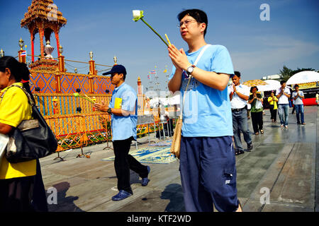 Gläubigen mit Blumen Spaziergang um ein Stupa während Magha Puja budhist Festival am Sanam Luang, Bangkok, Thailand Stockfoto