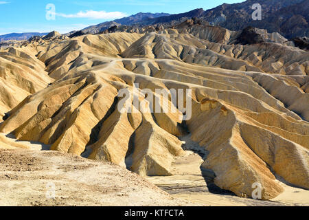 Golden badlands in Wellen, Falten und Furchen am Zabriskie Point im Death Valley National Park in den USA erodiert. Stockfoto