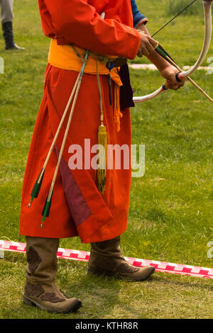 Männer und Frauen sind in festlicher Kleidung während Bogenschießen Wettbewerb gekleidet. Naadam festval in Bulgan Stadt. Stockfoto