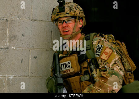 FORT DRUM, NY-Kapitän Jeffery Hansen, ein gemeinsames Endgerät angreifen Controller (Jtac), wartet auf seine Zündung Team der Feind Gefahrenbereich zu überqueren, um seine Mannschaft in Schutz zu ziehen und eine Beobachtung rally Point (ORP) während einer Übung in Fort Drum, NY Am 14. März 2015. 30 Flieger von der New York Air National Guard 274 Air Support Operations Squadron (ASOS) nahmen in enger Unterstützung aus der Luft (CAS) Ausbildung, die Ihre Fähigkeit, ein Ziel zu identifizieren und eine Bedrohung neutralisieren verbessert. Die 274 Mission ist uns Armeekommandanten auf, wie man am besten nutzen US- und NATO-Vermögen für Schließen Luft Sup zu beraten Stockfoto