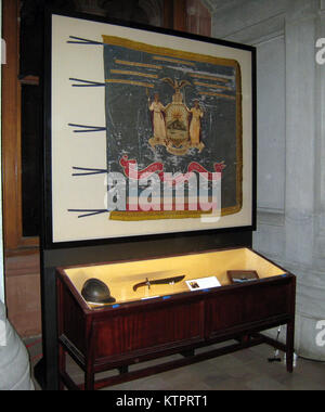 Diese Anzeige in der New York State Capitol War Room hebt die militärische Laufbahn von Sgt. Henry Johnson, an Albany New York National Guard Soldat, eine Ehrenmedaille erhalten, am 2. Juni 2015 seine heroische Welt wart ich Aktionen markieren. Johnsons Ehrenmedaille, zusammen mit einem französischen Helm wie das von Johnson und anderen Mitgliedern der 369 Infanterie Regiment, The Harlem Hellfighters, eine Armee getragen - Ausgabe bolo Messer, und ein 369 Infanterie Regiment patch, zusammen mit der Fahne des Regiments, sind auf dem Display. (Division von Militär und Marine Angelegenheiten Foto von Christopher Morton/freigegeben) Stockfoto