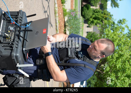 New York Air National Guard Master Sgt. Brian Gifford testet die Kommunikation kit außerhalb eines leer stehenden Wohnhauses im Burlington Air National Guard Base in Vermont am 27. Juli 2016. Die Mitglieder des 2. Zivile Support Team an der Basis zu verbessern die Fähigkeit ihres Teams zu schnell chemische Detektion und Analyse von Test- und geschult, biologischen, radiologischen oder nuklearen (CBRN) Gefährliche und auf diese Bedrohungen reagieren. (U.S. Army National Guard Foto vom Kapitän Jean Marie Kratzer) Stockfoto