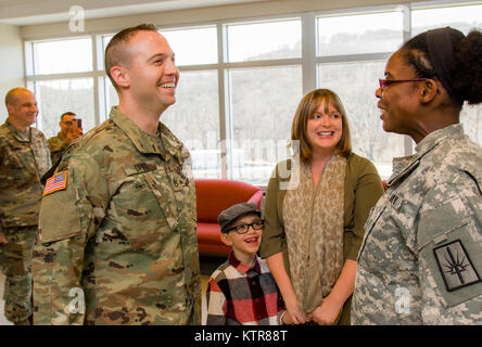 Staff Sgt. Michael Davis, 138 Öffentliche Angelegenheiten Loslösung, wird gefördert und von seiner Frau Megan Davis im Camp Smith, N.Y., Dez. 4, 2016 festgesteckt. (U.S. Army National Guard Foto von Sgt. Harley Jelis) Stockfoto