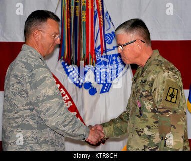 LATHAM, N.Y.-- Generalmajor Anthony Deutsch, der Adjutant General von New York (links), gratuliert Chief Warrant Officer 5 Robert Wold, die ausgehende Befehl Chief Warrant Officer der New York Army National Guard (rechts) nach der Verleihung der Staat New York auffällige Service Medal während eines Change-of-behörde Festakt in New York National Guard Sitz hier am 9. Chief Warrant Officer 4 Jeffrey Schirmer übernahm Chief Warrant Officer Aufgaben während der Zeremonie. Schirmer, ein Leicester N.Y. Bewohner und ein Veteran von zwei Kriege, die für die Rekrutierung Haftbefehl offic verantwortlich. Stockfoto