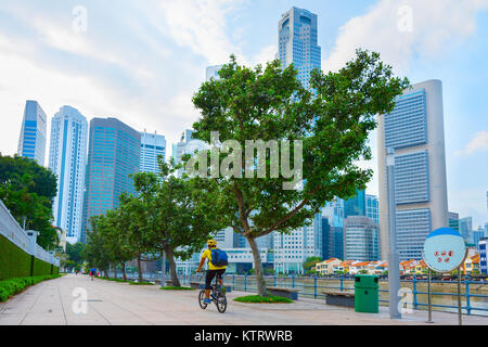 Unbekannter Mann reiten Fahrrad auf dem Singapore River Embankment Stockfoto