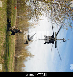 Pvt. Harris Saifi, ein 10 Mountain Division Soldat von Queens, New York, zieht der Sicherheit als Bodenpersonal in der dritten Bataillon der New York Army National Guard, 142 Aviation Luftbrücken ein Dutzend 105 mm Haubitzen zu Alpha Batterie ist der 10 Mountain Division, 2.Bataillon, 15 Field Artillery Regiment während einer Übung hier am 4. Mai 2017. Zusätzlich zur Bereitstellung von für den Bereich und die Einrichtung ihrer Logistik und Sitz, 3. Bataillon Truppen geplant, vorbereitet und geprobt und ausgeführt, die Luftbrücke Mission - die 105-mm-Haubitze Munition und 10 Mountain Division Truppen - wi Stockfoto