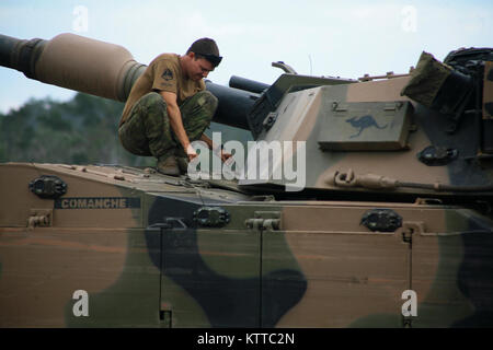 SHOALWATER BAY, AU-Trooper John Wilkinson, eine australische Soldaten bis zum 2. Kavallerie Regiments, Australian Defence Force zugewiesen, inspiziert ein M1 Abrams Tank während der Übung Talisman Sabre, Juli 10. Während der Übung der australischen Streitkräfte ihre Kampftechniken neben USA und Neuseeland service Mitglieder schärfen wird. (U.S. Army National Guard Foto von Sgt. Alexander Rektor) Stockfoto