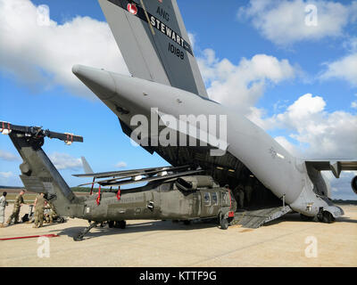 New York Army National Guard Soldaten der dritten Bataillon, 142 Aviation Regiment, in Ronkonkoma, New York, laden zwei UH-60 Blackhawk Hubschrauber in Islip MacArthur Airport in eine C-17 Globemaster von 105 Airlift Wing der New York Air National Guard von Newburgh, New York, 27. September 2017 geflogen. Die New York National Guard ist die Bereitstellung von vier Blackhawks und 60 Piloten und Masse an den Support, um Puerto Rico zur Unterstützung von Verwertungsverfahren für die Puerto Rico National Guard. Foto vom Kapitän Mark Getman, New York Schutz staatlicher Verteidigung. Stockfoto