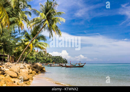 Boote am tropischen Strand mit Palmen, südlichen Ende der Bang Tao Beach, Phuket, Thailand Stockfoto