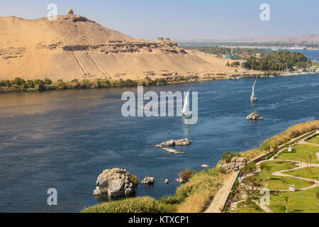 Blick auf den Fluss Nil, Gräber der Adligen auf der Westbank, die Elephantine Insel, und die Gärten der Mövenpick Resort Assuan, Oberägypten, North Afric Stockfoto