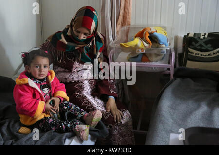 Jordan. 21 Jan, 2017. Eine Frau sitzt mit ihrem neugeborenen Baby an der UNFPA-run Mutterschaft Zentrum in Zaatari syrischen Flüchtlingslager. Durchschnittlich werden 70 Babys pro Monat sind dort geboren. Zur Zeit sind über 700.000 syrische Flüchtlinge in Jordanien die Flucht aus dem Konflikt in der Nation, die seit 2011 begonnen. Credit: Sally Hayden/SOPA/ZUMA Draht/Alamy leben Nachrichten Stockfoto