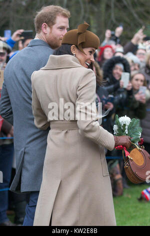 Bild vom 25. Dezember 2017 zeigt Meghan Markle und Prinz Harry am Weihnachtstag morgens Gottesdienst in der St. Maria Magdalena Kirche in Sandringham, Norfolk. Stockfoto