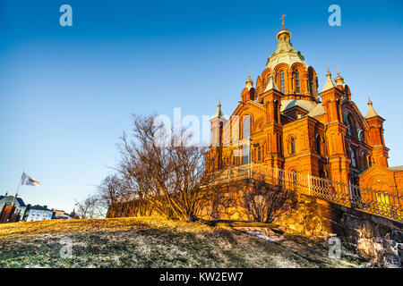 Schönen Blick auf berühmte Orthodoxe Uspenski-kathedrale (Uspenskin katedraali) auf einem Hügel im goldenen Abendlicht bei Sonnenuntergang, Helsinki, Finnland Stockfoto