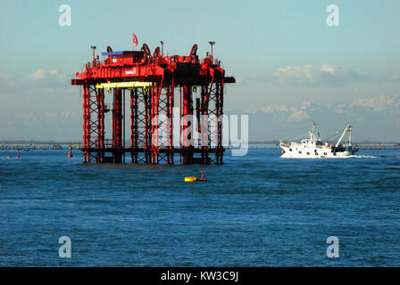 Das Projekt MOSE Barriere und Gantry Lift an der Lagune Chioggia, Venedig, Italien, mit einem 210 Tonnen schweren Tor auf einem Lastkahn von Ingenieuren geprüft werden. MOSE war entworfen, um Venedig Acqua Alta zu schützen oder Überschwemmungen durch die Flut der Lagune durch den Klimawandel, aber hat in Korruption seit der Gründung beschmutzt worden und ist noch nicht betriebsbereit. Stockfoto