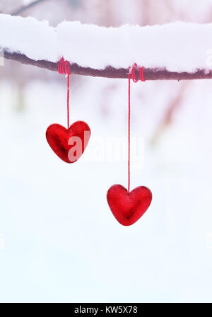 Roten Herzen auf verschneiter Baum im Winter. Urlaub happy valentines Tag, liebe Konzept. Stockfoto