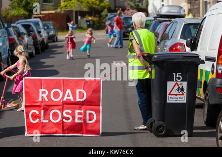 Eine Straße wird von Freiwilligen geschlossen als Kinder auf den Straßen spielen als Teil der "Bristol" heraus spielen. Stockfoto