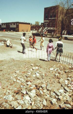 Schwarze Kinder spielen außerhalb des Ida B Brunnen Wohnungen, einem der ältesten Chicago Wohnungsbau, Illinois, Mai, 1973. Bild mit freundlicher Genehmigung von John White/US National Archives. Mit freundlicher Genehmigung der nationalen Archive. Stockfoto