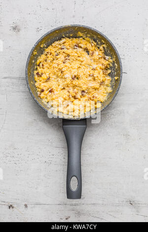 Schinken und Eiern. Rührei mit Speck in Keramik pan. Stockfoto