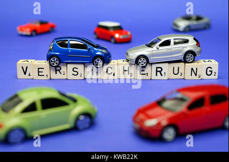 Miniatur-Autos die Schlaganfall-Qualitätssicherung, symbolische Foto Fahrzeug Qualitätssicherung, Miniaturautos Auf Dem Schriftzug Versicherung, Symbolfoto Kfz-Versicherung Stockfoto