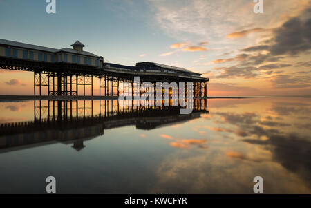 Central Pier in Blackpool mit Sonnenuntergang und Reflexion im Wasser Stockfoto