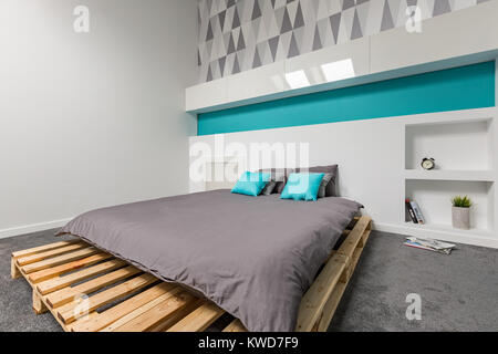 Einfache und moderne Schlafzimmer mit Bett und gemusterte Tapeten Stockfoto