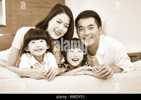 Porträt einer asiatischen Familie mit zwei Kindern, glücklich und lächelnd, Schwarz und Weiß Sepia. Stockfoto