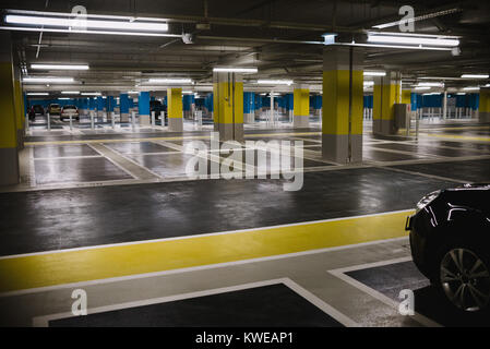 Nahaufnahme auf Tiefgarage mit leeren Steckplätze und Auto Stockfoto