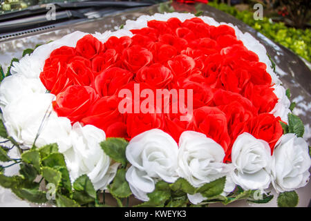 Herzförmige rote und weiße Rosen Blumen Hochzeit Blumenstrauß vor das Auto des frisch vermählte Paar. Zeichen und Symbol der Liebe, Hochzeit, Neuanfang und Ro Stockfoto
