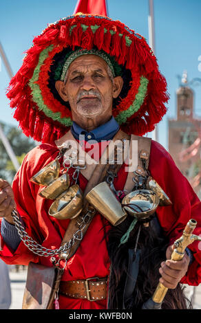 Traditionelle Wasser Verkäufer und der Koutoubia-moschee mit marokkanischen Flagge. Stockfoto