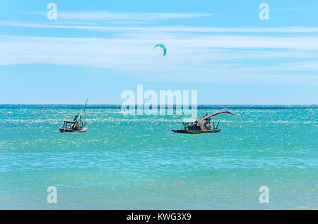 Jangada Boot und Kite-Surfer zusammen Segeln auf dem Meer in Cumbuco, Brasilien Stockfoto