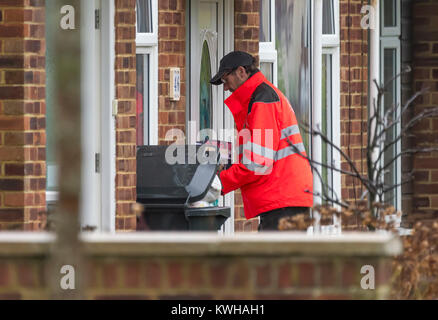 Royal Mail Briefträger die Post durch einen Buchstaben, um ein Haus in England, Großbritannien. Stockfoto