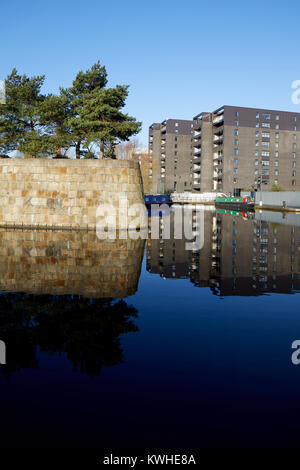 Marina an der Neuen Islington, Ancoats, Manchester, mored narrowboats als Häuser und neue Wohnung Gebäude spiegeln sich in der Stille Wasser Stockfoto