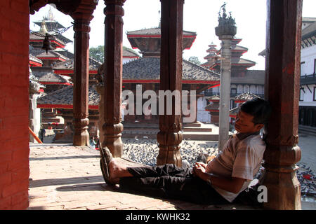 KATHMANDU, Nepal - ca. November 2013 schlafenden Mann im hinduistischen Tempel des Durbar Square Stockfoto