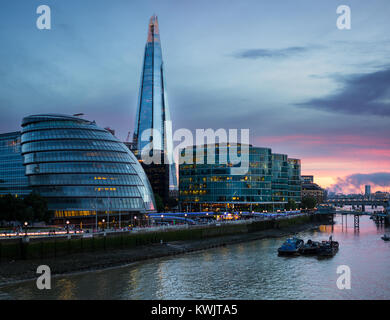 Der Shard und Londons Rathaus von der Tower Bridge gesehen, wie der Himmel rot am Ende des Tages drehen Stockfoto