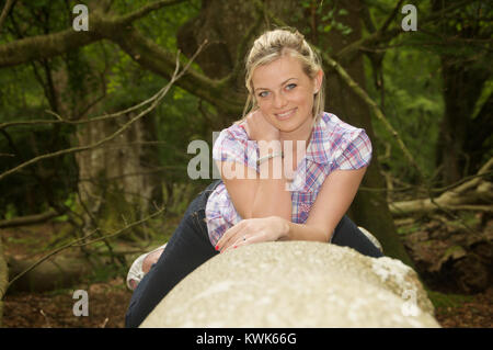 Schöne blonde Mädchen trägt ein kariertes Hemd in einem Wald Lage Stockfoto