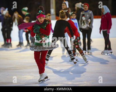 Bettendorf, Iowa, USA. 22 Dez, 2016. Sydney Struss, 9, von Davenport Spins auf ihre Skates auf der Eisbahn im Freien bei Frozen Landung in Bettendorf am Donnerstag, 22. Dezember 2016. Skater aus der Abbildung Eislauf Club der Quad Cities nahm, um das Eis zu Viele in Urlaub Kostüme für ein Flash Mob stil Leistung. Credit: Andy Abeyta/Viererkabel - Zeiten/ZUMA Draht/Alamy leben Nachrichten Stockfoto