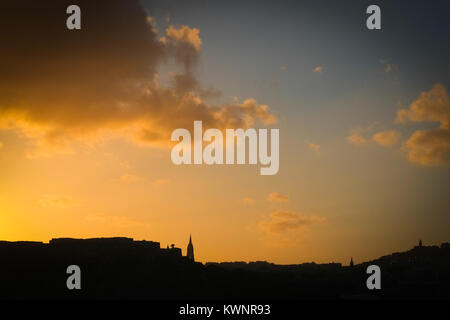 Mgarr, Gozo skyline Silhouette vom Meer mit Kirchen, Wolken und Sonnenuntergang Farben Stockfoto