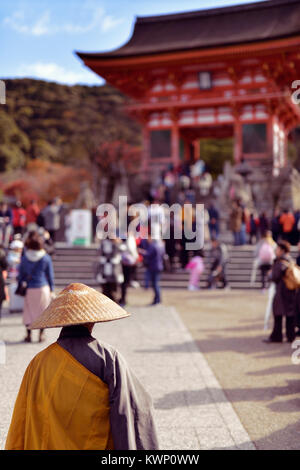Japanischer buddhistischer Mönch vor der Kiyomizu-dera Tempel Eingang voll mit Touristen. Kyoto, Kyoto, Japan 2017. Stockfoto