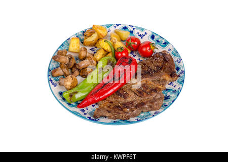 Detaillierte Ansicht von lecker lecker Gegrilltes Steak auf Holzplatte mit Kartoffel, Tomate und Paprika diente, auf weißem Hintergrund. Stockfoto