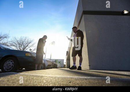 Davenport, Iowa, USA. 20 Mär, 2017. Der lokale Rapper Tanner' keez'' Rodman, rechts, bei seinem Telefon warten auf ein Ticket Käufer ihm beim Treffen mit William Brandle Werbeflyer in Davenport am Montag, den 20. März 2017 zu entsprechen. Rapper Tech N9ne in Davenport und lokaler Künstler, Tanner "Keez'' Rodman, wird eine Öffnung handeln. Credit: Andy Abeyta/Viererkabel - Zeiten/ZUMA Draht/Alamy leben Nachrichten Stockfoto